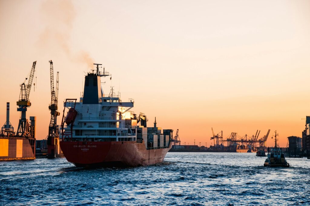 pexels-photo-799091-799091 Stunning sunset view of cargo ships and cranes at the Port of Hamburg, epitomizing global trade and logistics.